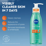 NIVEA Derma Skin Clear Scrub in a clear aqua pump bottle with a white dispenser and orange label accents