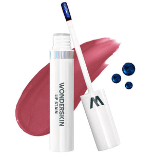 Wonderskin Wonder Blading Lip stain in a white tube with wand, shown beside a rosy pink swatch and blue pigment dots.