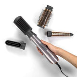 BaByliss 4 in 1 Hair Dryer Styler with a metallic rose-gold handle and interchangeable black and copper styling attachments