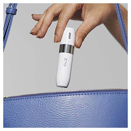 Braun facial hair remover being placed into a blue handbag