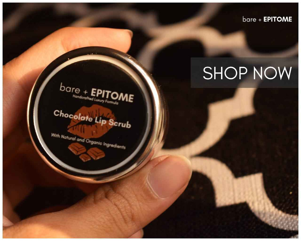 Chocolate Lip Scrub in a round black jar with a metallic silver rim and chocolate graphics on the lid.