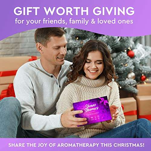 Couple exchanging Cleverfy Shower Steamers aromatherapy gift set by Christmas tree
