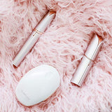 Finishing Touch Flawless facial hair remover set with white oval case and two slim metallic rose-gold grooming devices
