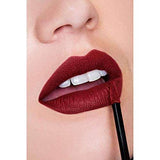 Maybelline Superstay Matte Ink liquid lipstick in deep burgundy, applied as a richly pigmented matte finish with an applicator