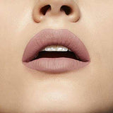 Maybelline Superstay Matte Ink lipstick shown as muted dusty rose nude color on lips with a smooth matte finish