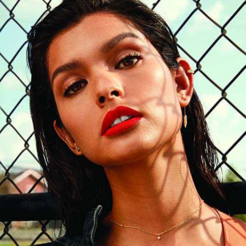 Maybelline Superstay Matte Ink lipstick in vibrant orange-red, shown as a bold matte lip color on a model.