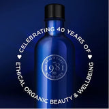 Blue Neal’s Yard Remedies bottle celebrating 40 years of ethical organic beauty