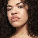 NYX Soft Matte Lip Cream in a muted peachy nude shade, shown on lips with a smooth matte finish