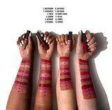 NYX Soft Matte Lip Cream tubes in assorted shades held above arms displaying numbered lipstick swatches