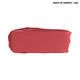 Rimmel London Lasting Finish Lipstick shown as a muted rose-red swatch with a smooth creamy texture and softly uneven edges